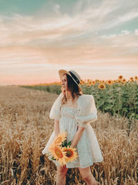 Rear view of woman standing on field