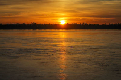 Scenic view of lake against romantic sky at sunset