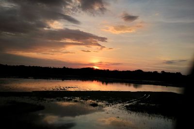 Scenic view of lake against sky during sunset