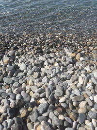 High angle view of pebbles on beach