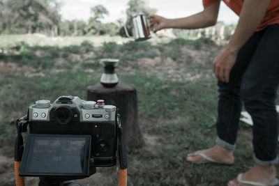 People photographing camera on land