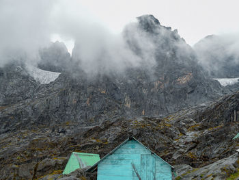 A cabin in mountain range in foggy weather, elena hut in the rwenzori mountain range, uganda 