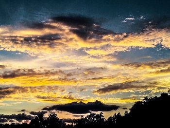 Low angle view of cloudy sky at sunset