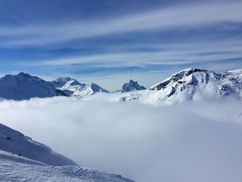 Scenic view of snowcapped mountains against sky