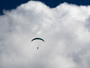 Low angle view of paragliding against sky