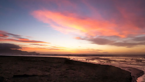 Scenic view of sea against romantic sky at sunset