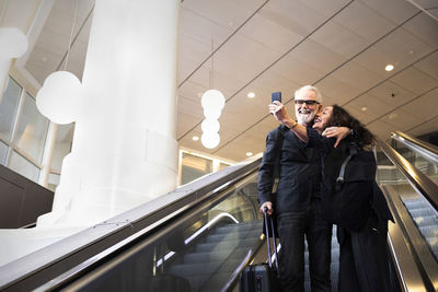 Mature couple on escalator