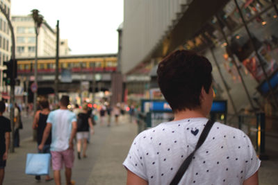 Rear view of people walking in city