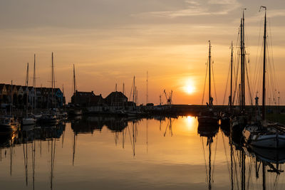 Sailboats in marina at sunset