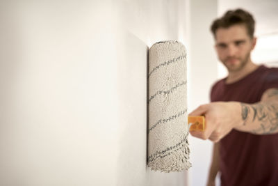 Portrait of man standing against wall