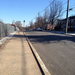 Empty road along buildings