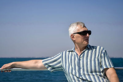 One man in sunglasses is resting on yacht in red sea. close-up. hurghada, egypt