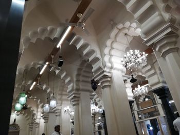 Low angle view of illuminated chandelier hanging in building