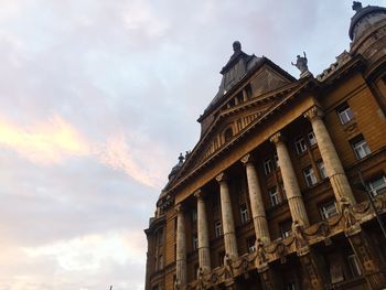 Low angle view of building against cloudy sky