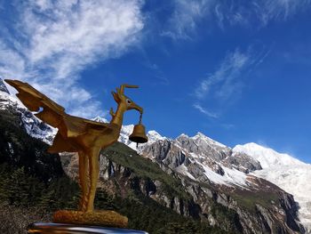 Low angle view of statue against blue sky