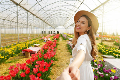 Woman looking over shoulder in greenhouse