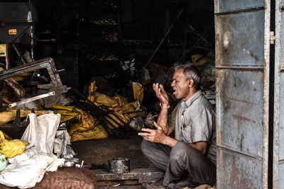 Side view of man using mobile phone