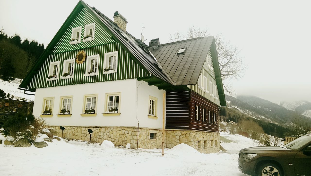 architecture, built structure, building exterior, mountain, house, clear sky, sky, roof, residential structure, tree, day, outdoors, residential building, no people, incidental people, religion, exterior, place of worship, facade, travel destinations