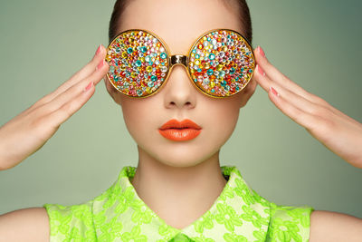 Portrait of woman wearing multi colored sunglasses