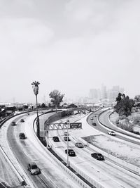 Traffic on road in city against sky