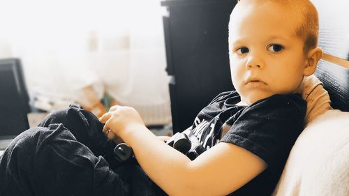 Portrait of cute girl sitting at home