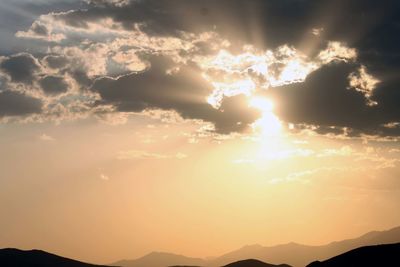 Scenic view of mountains against sky at sunset