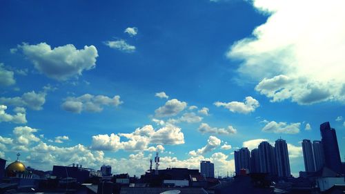 Panoramic view of buildings against blue sky