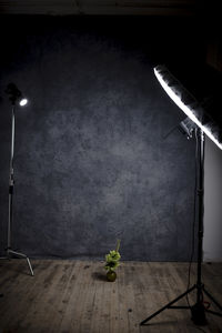 View of illuminated electric lamp against wall