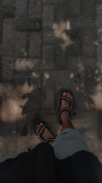 Man wear a sandals standing on floor