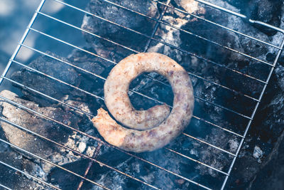 High angle view of hot dog on metal grate