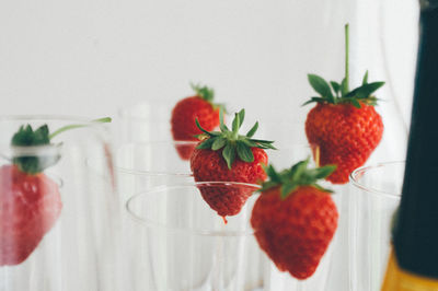 Close-up of strawberries with drinking glasses