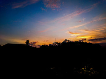 Scenic view of silhouette trees against sky during sunset