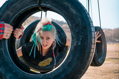 Woman with colorful hair playing at playground