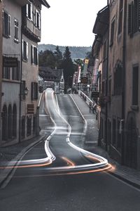 Vehicles on road amidst buildings in city