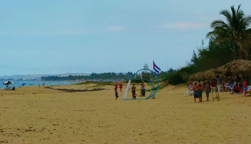 People on beach against sky