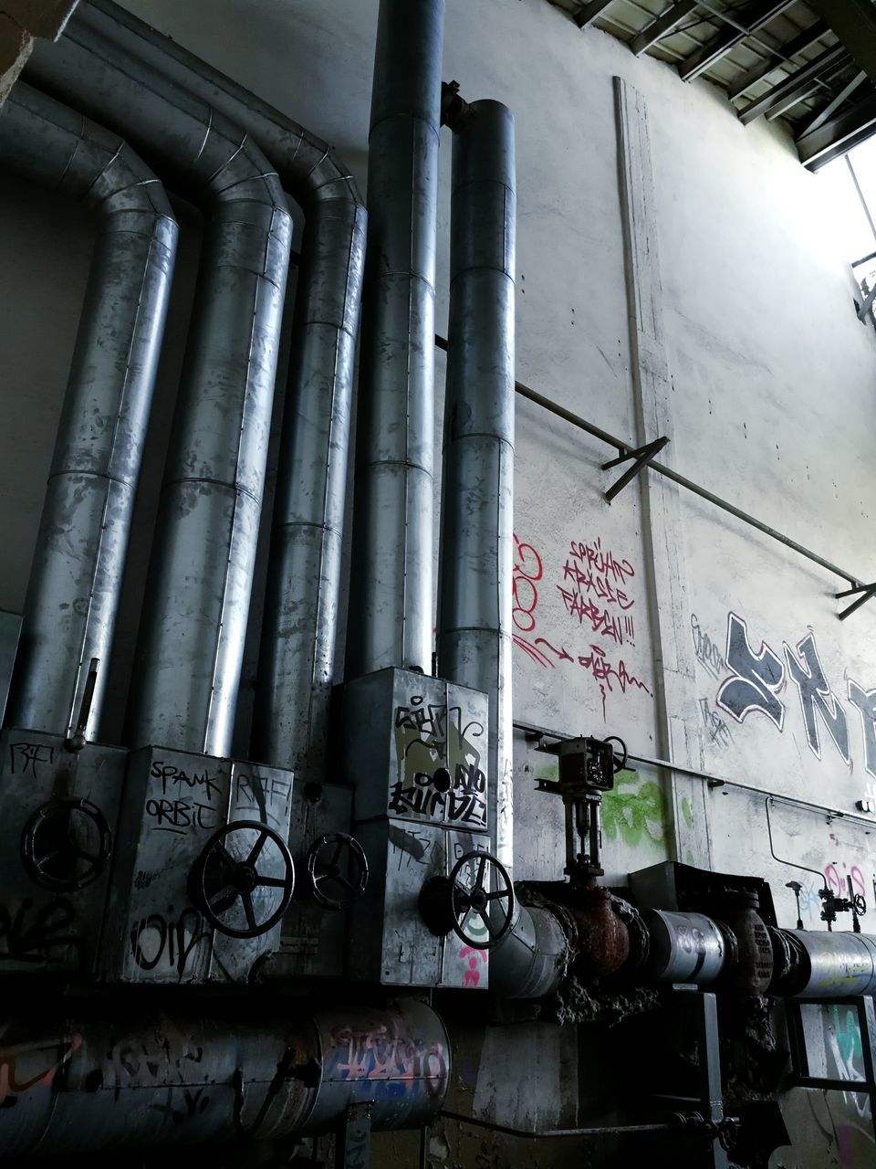 built structure, indoors, low angle view, pipe - tube, text, no people, architecture, factory, day