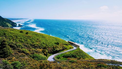 High angle view of road by sea against clear sky