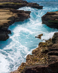 High angle view of rocks at sea shore