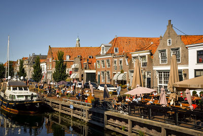 Group of people in city against buildings