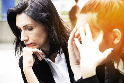 Stressed businesswomen sitting outdoors