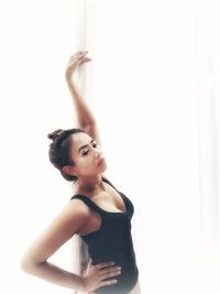 Young woman looking away against white background