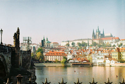 Buildings in city against clear sky