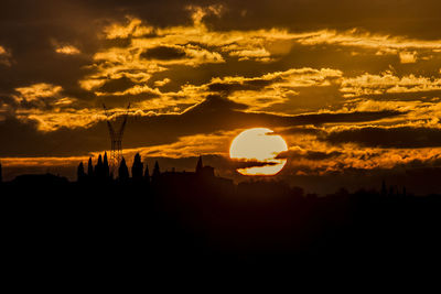 Silhouette landscape against romantic sky at sunset