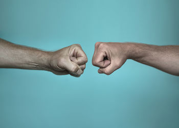 Close-up of hands over blue background