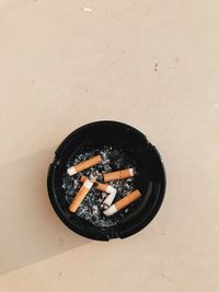 High angle view of cigarette smoking on table