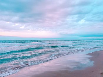 Scenic view of beach against sky during sunset