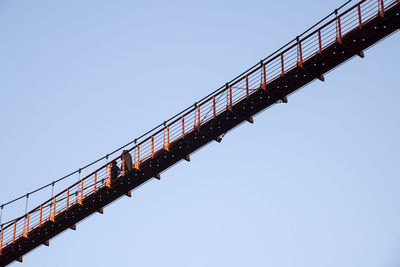 Low angle view of crane against clear sky