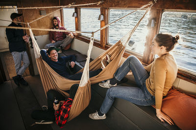 Happy friends enjoying leisure time together on boat