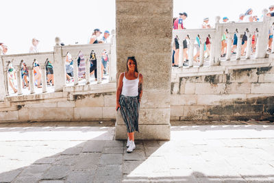 Woman standing against wall