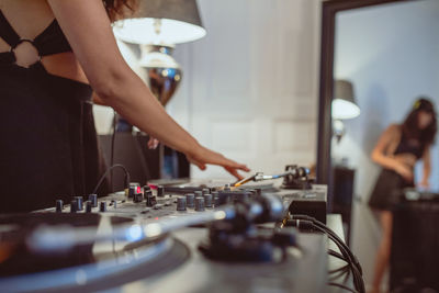 Fashionable young woman playing music at home